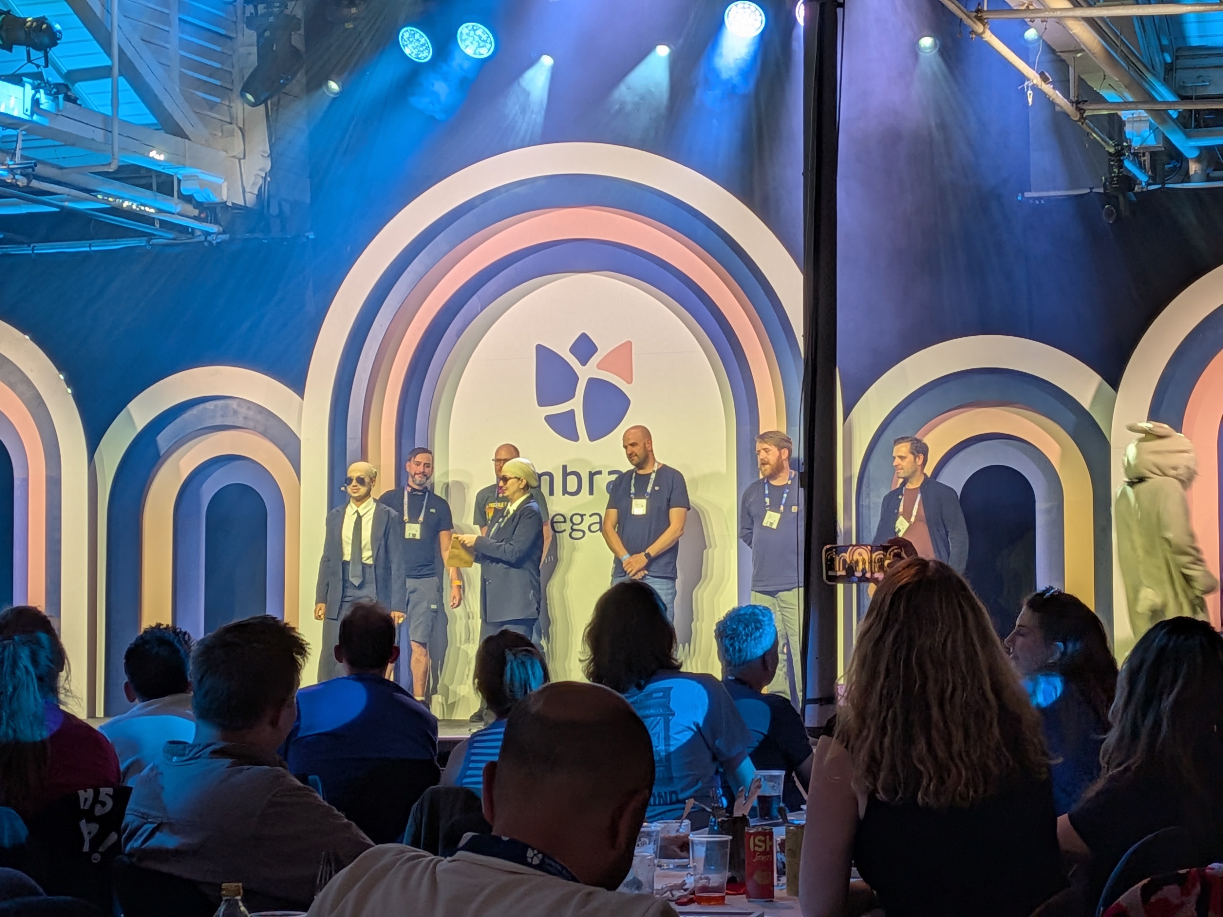 Nominee's for the Umbraco Package Award stood on a stage, waiting for two people dressed as Pitbull to announce the winner.