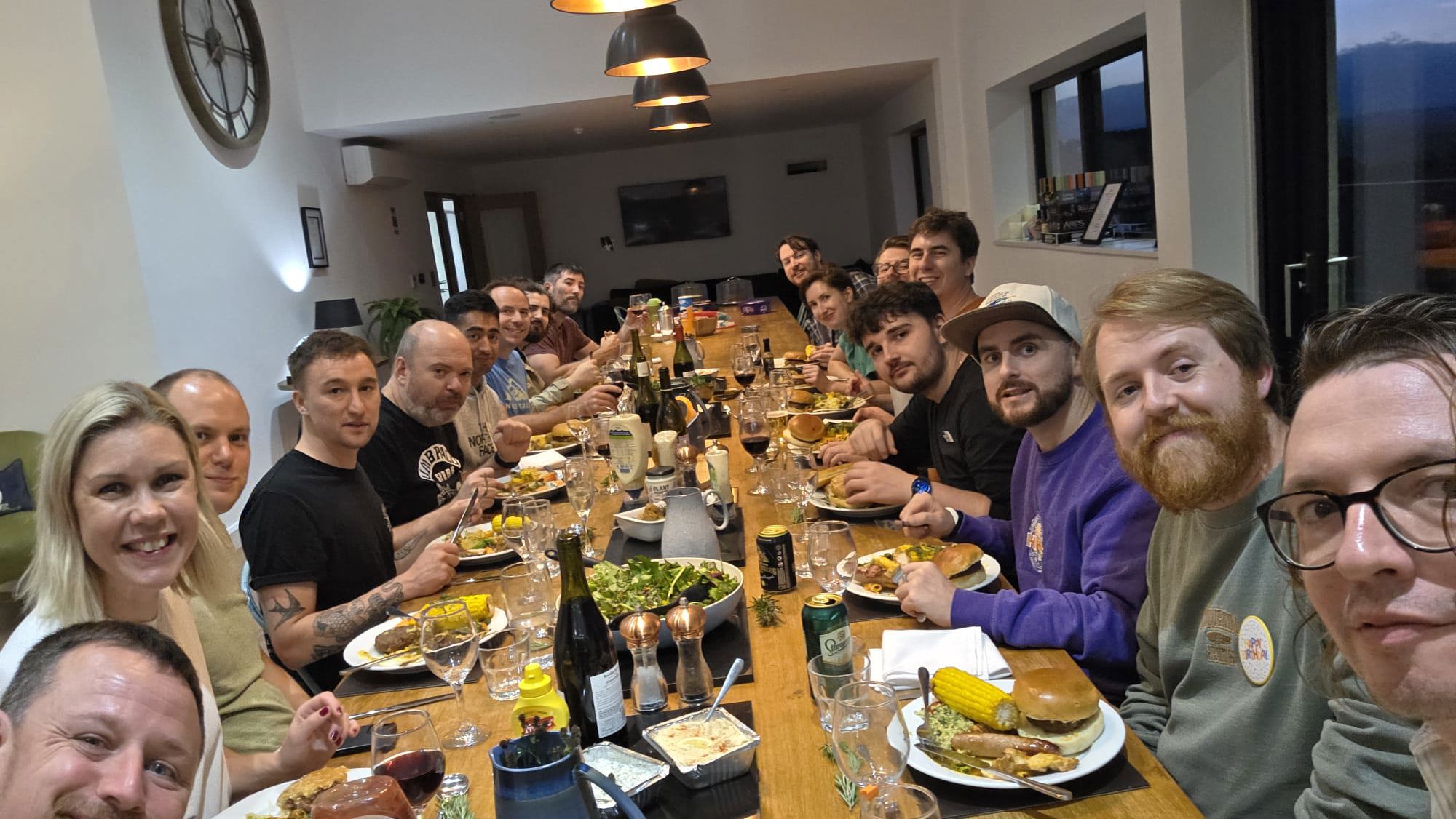 The team sat together at a long table enjoying a meal.